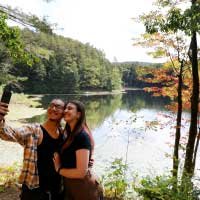 couple taking selfie by lake